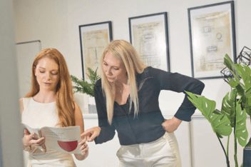 Leann and Rachel review a transcript together in an office