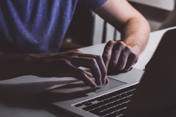 Man typing on a laptop