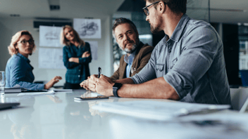 Two people speaking in a conference room