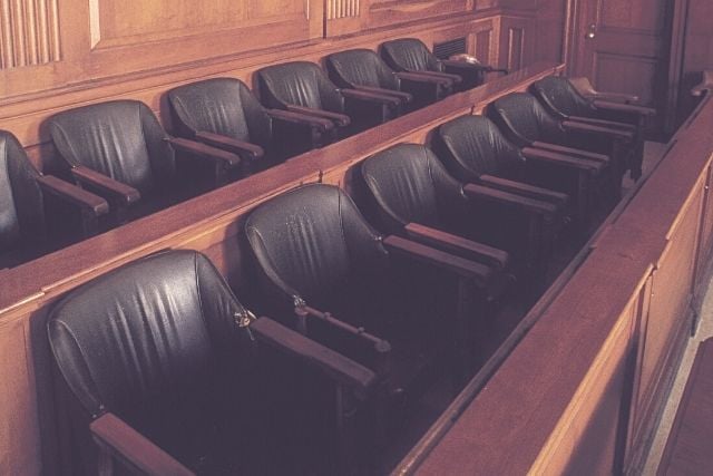 Empty jury seats in a courtroom