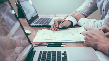 People working on expenses at computers