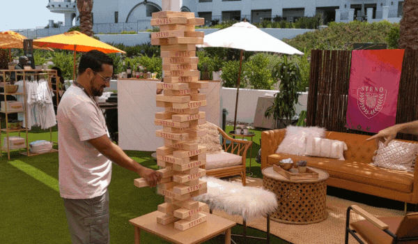 Albert pulling a block out of a high stack of jenga blocks