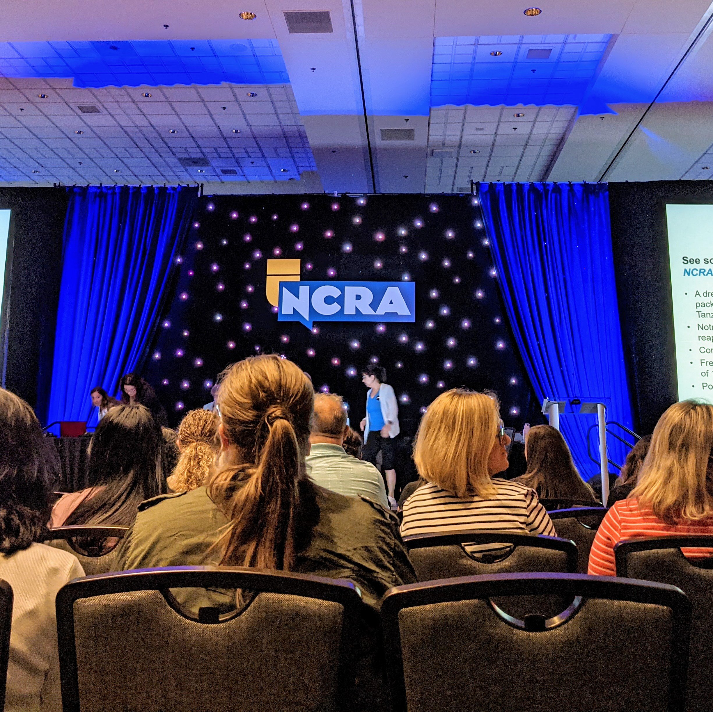 Group of people sitting in a conference hall at NCRA