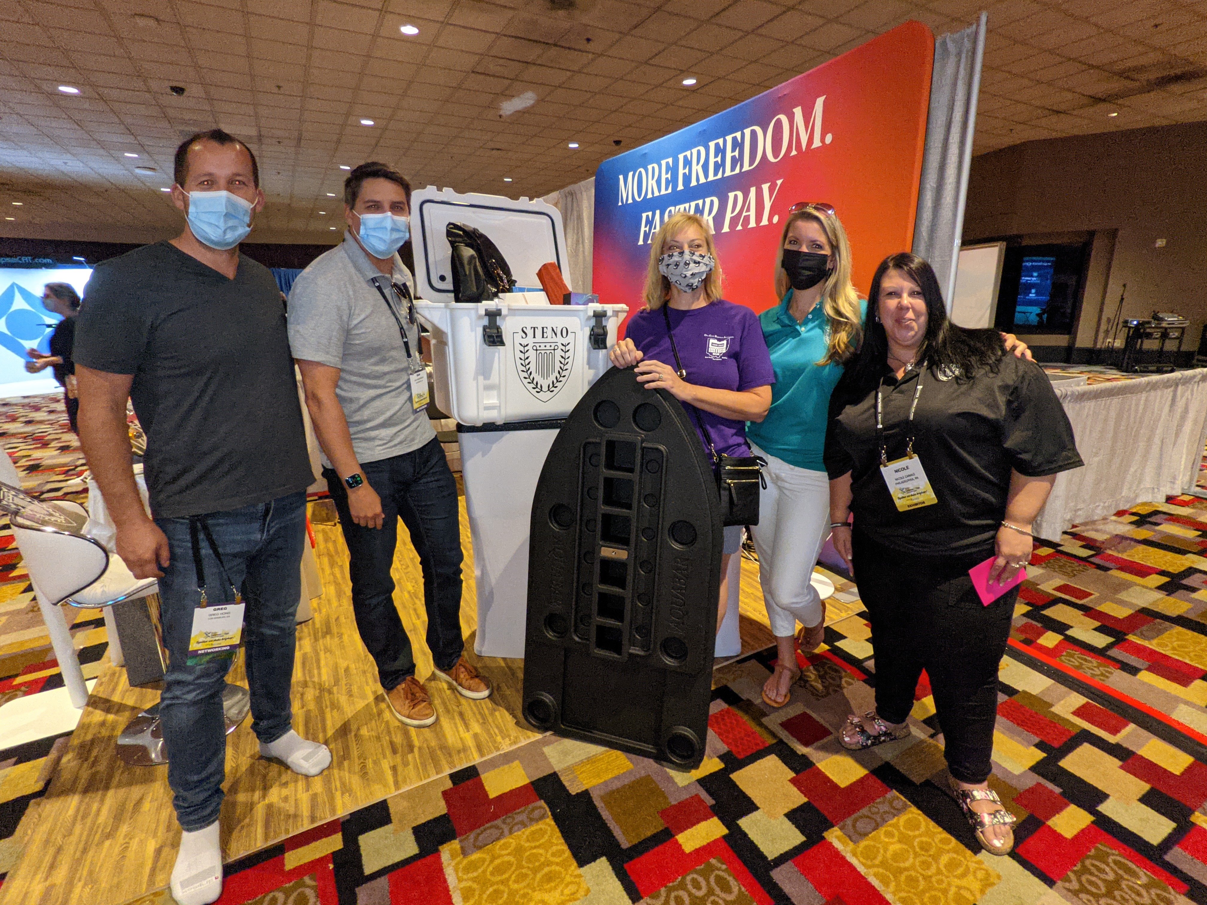 Steno team members pose with the prize and the raffle winner at the Steno booth in the NCRA expo hall.