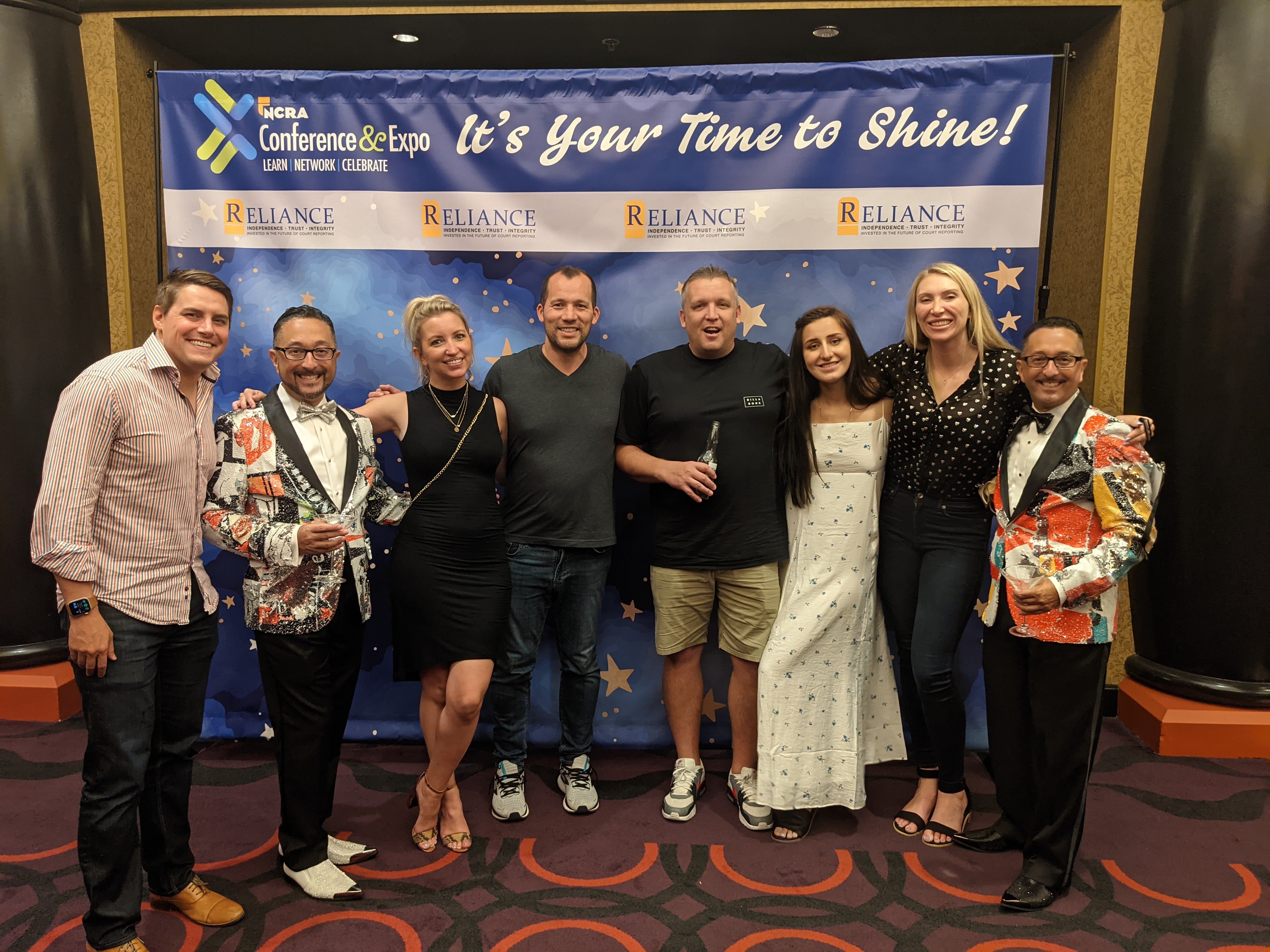 Group posing in front of a step and repeat at the NCRA member recognition gala