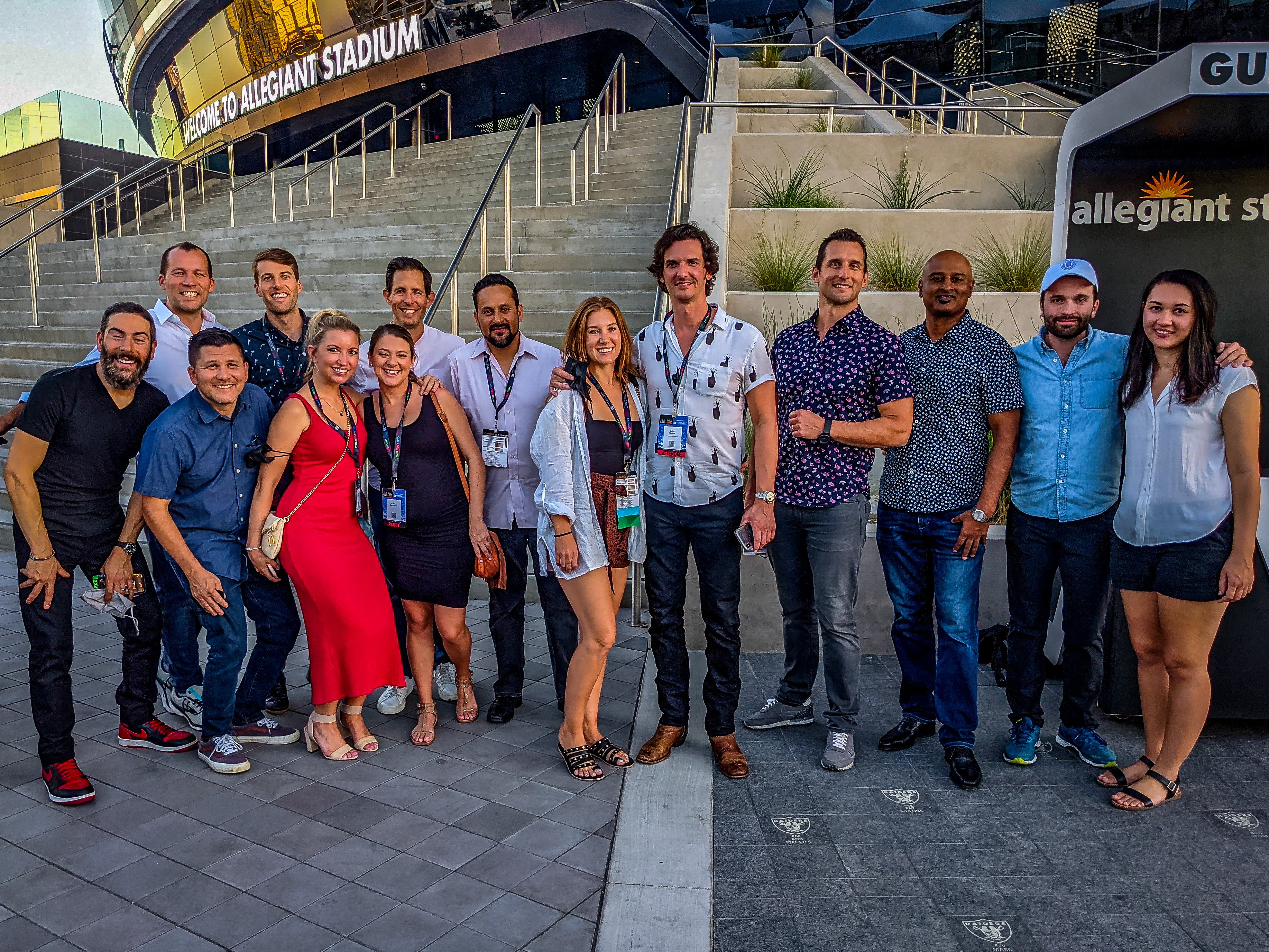 A group of Steno staff and guests pose outside of the Allegiant Stadium steps