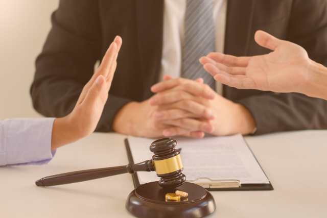 Three people sitting in a court meeting.